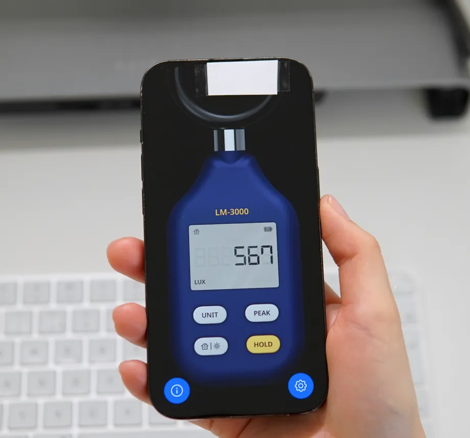Paper diffuser taped over the front camera of an iPhone running the Light Meter LM-3000